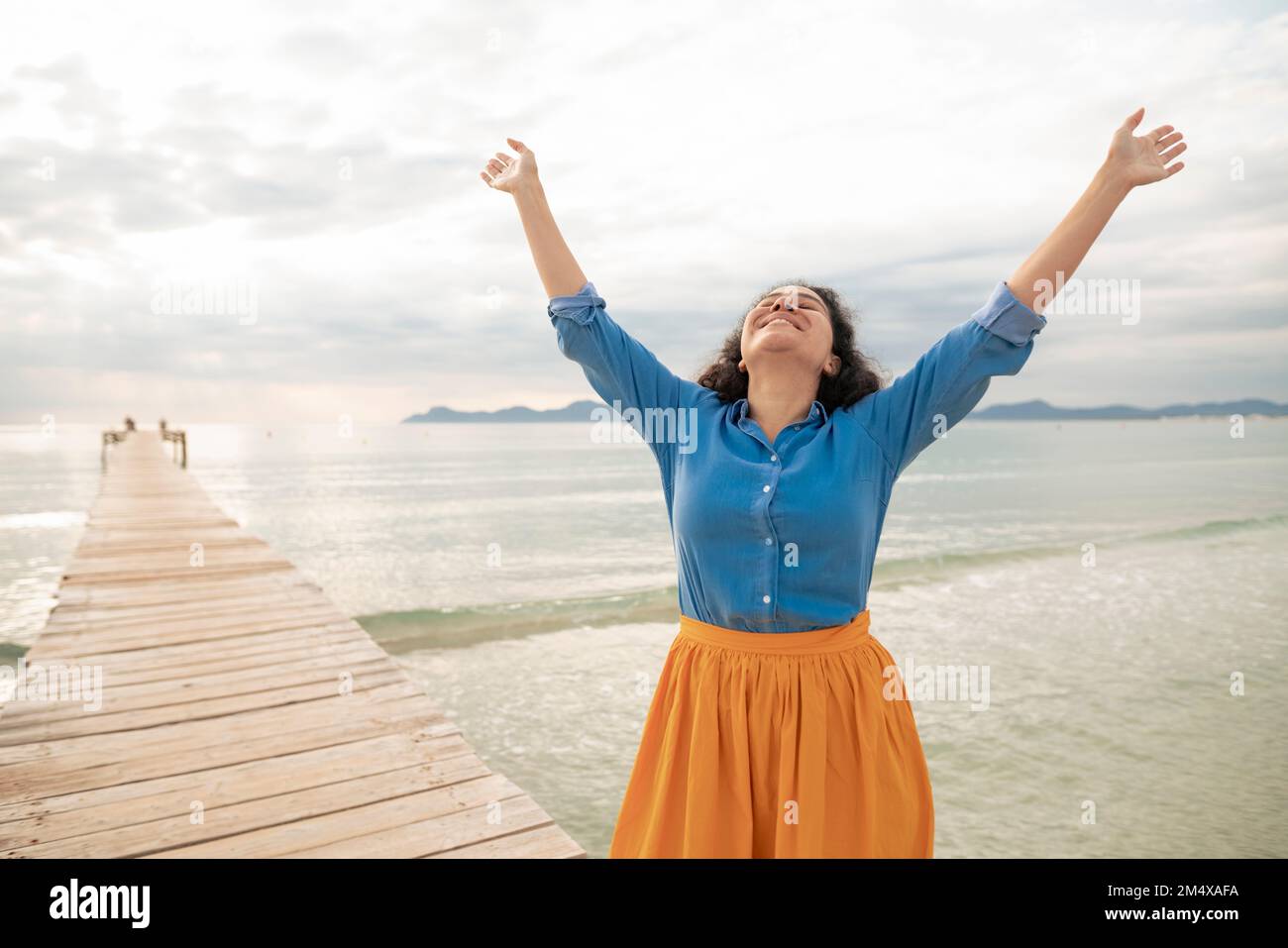 Woman standing sea raised arms hi-res stock photography and images - Alamy