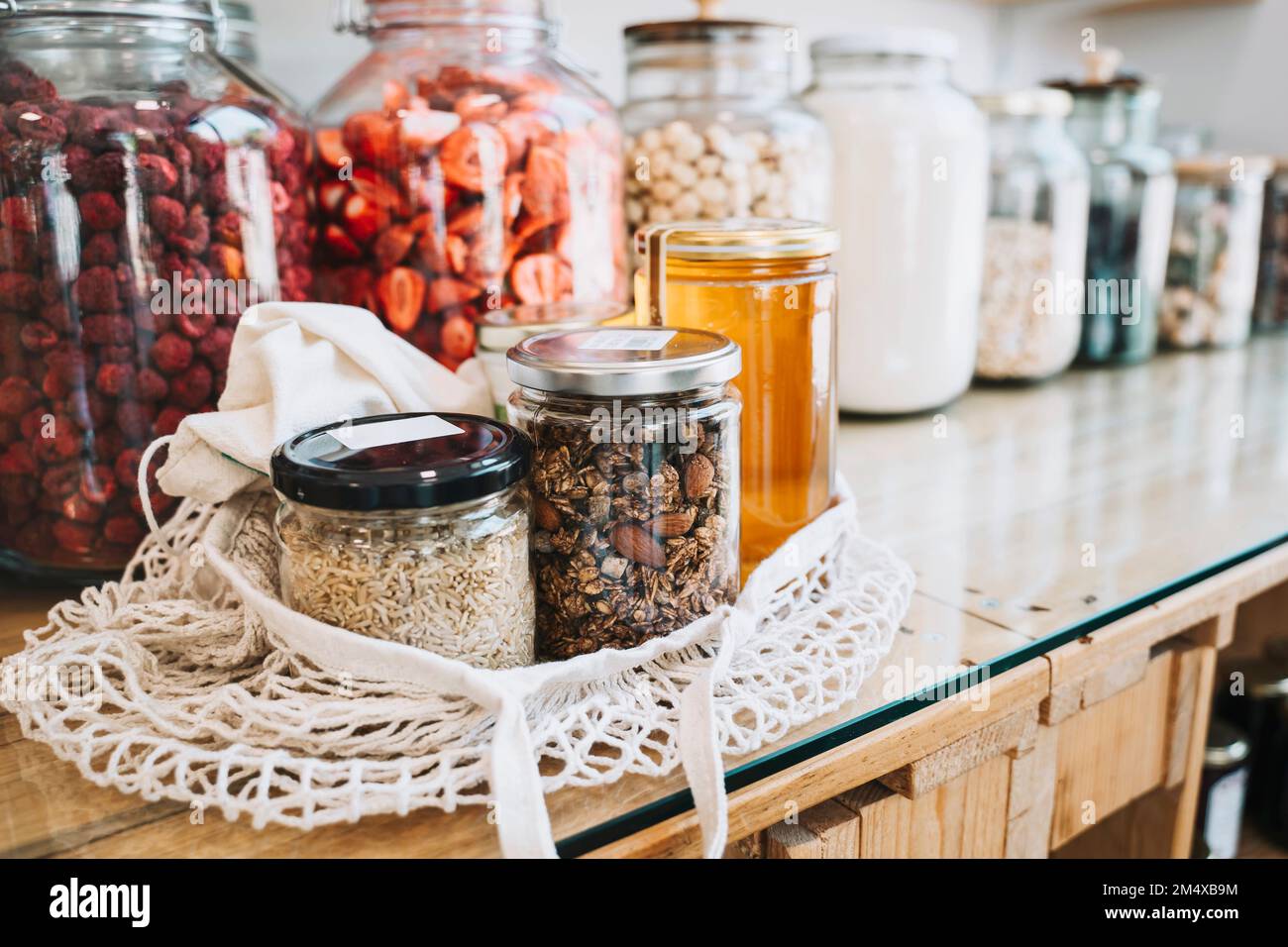 Raw food in mason jars on table at sustainable store Stock Photo