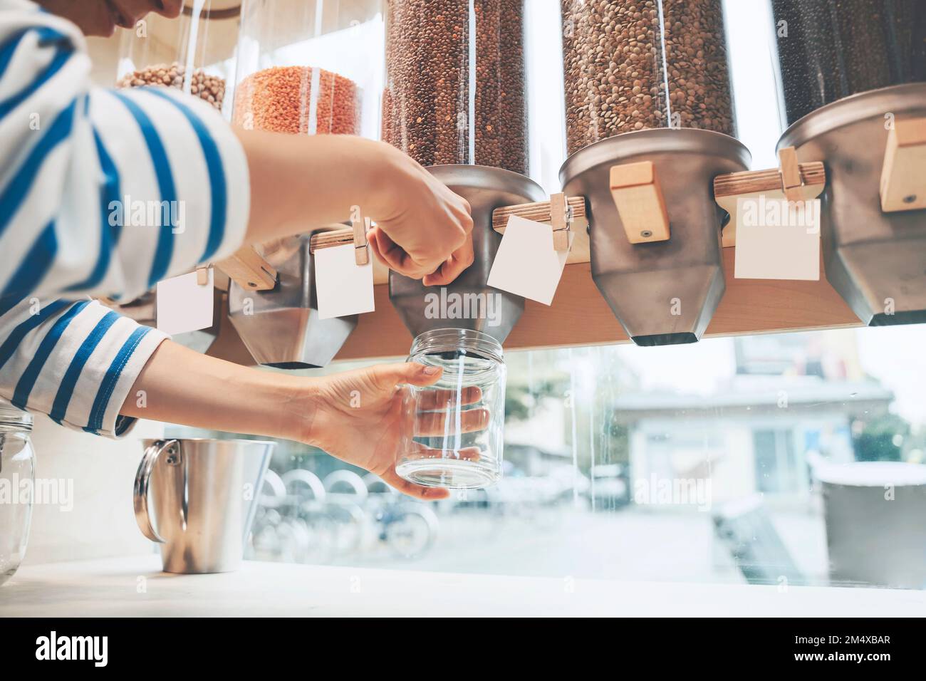Customer filling jar with lentils at zero waste store Stock Photo Alamy