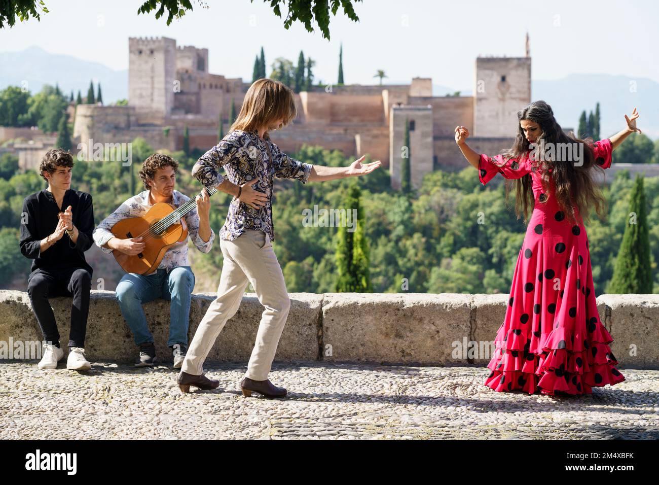 Flamenco dancers and guitarist performing in front of Alhambra, Granada, Spain Stock Photo
