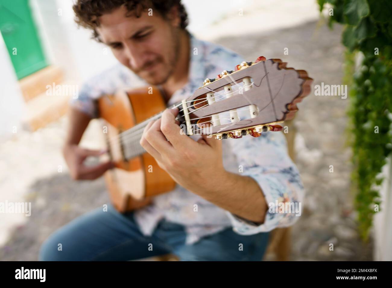 Musician playing Flamenco guitar sitting on chair Stock Photo Alamy