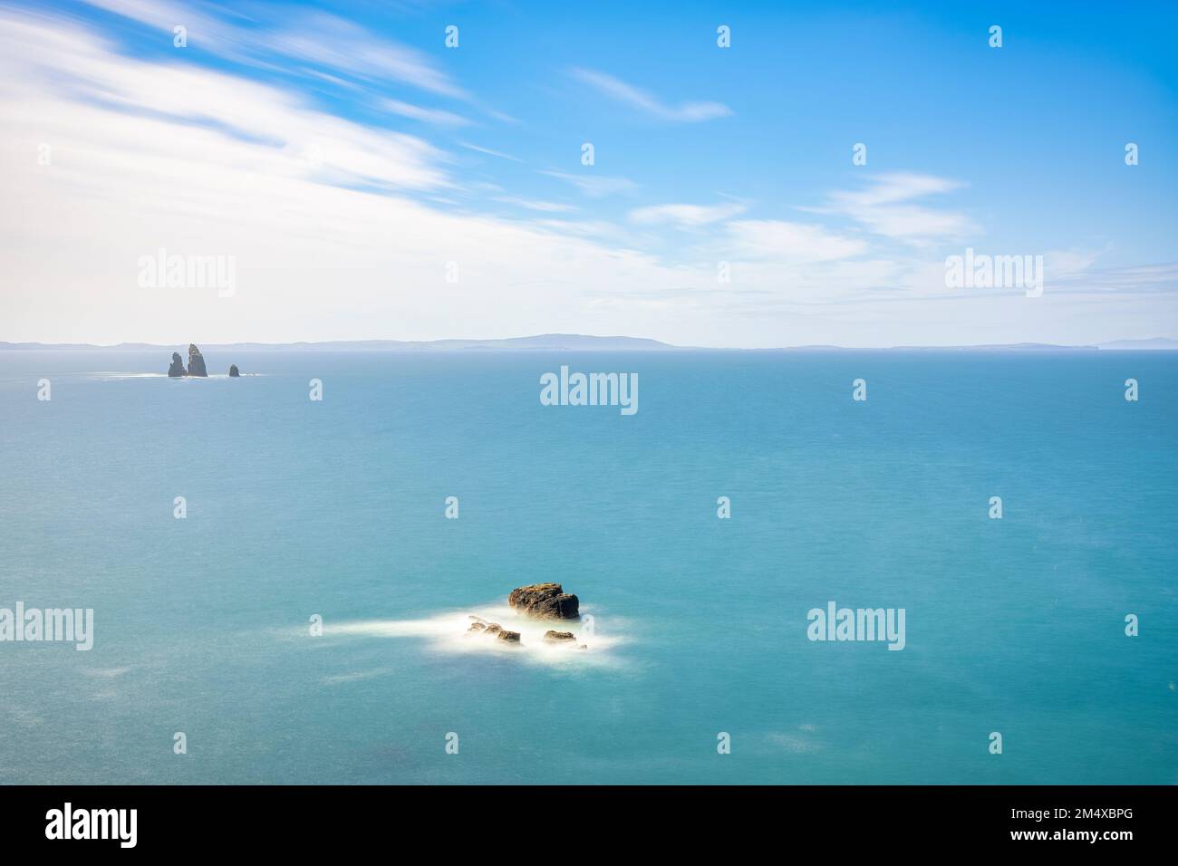 UK, Scotland, Aerial view of blue sea with Drongs sea stacks in background Stock Photo