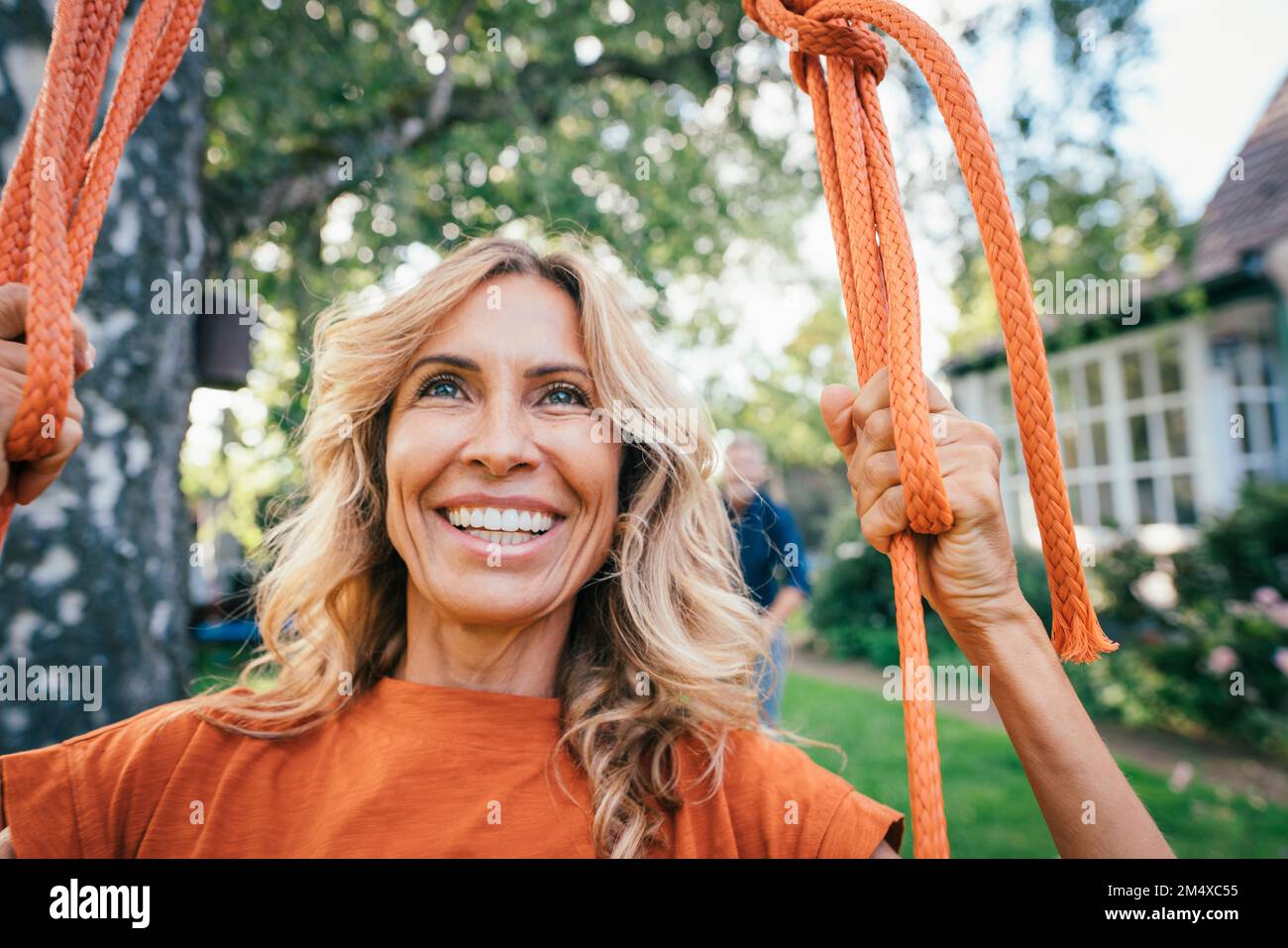 Mature woman sitting on swing hi-res stock photography and images - Alamy