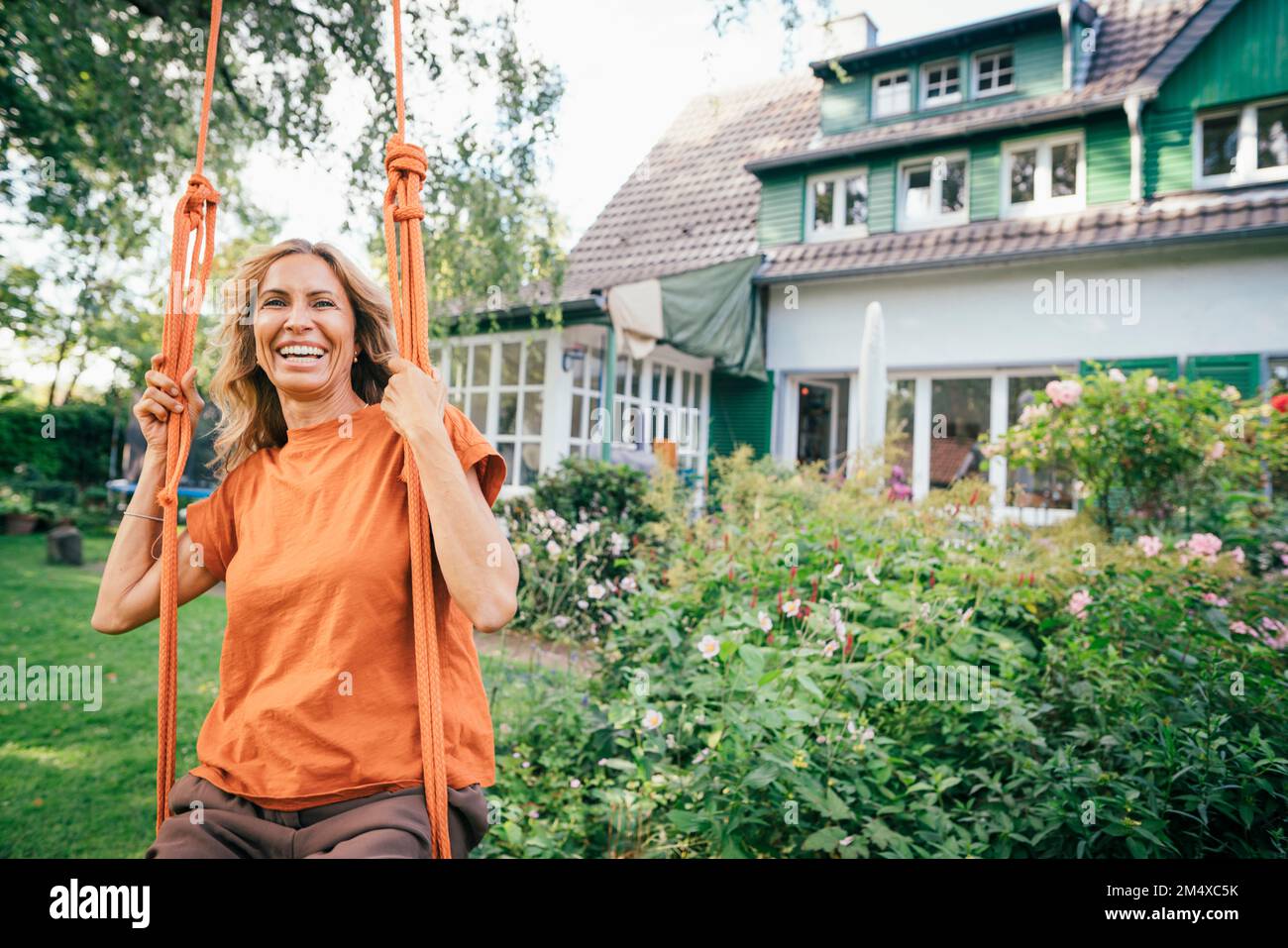 Mature woman sitting on swing hi-res stock photography and images - Alamy