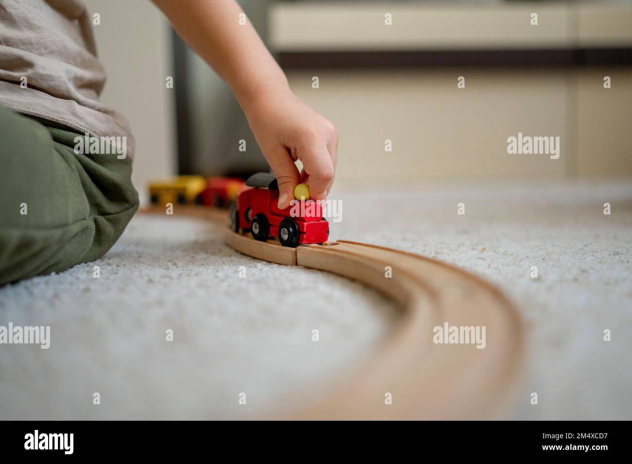 Hand of boy playing with wooden toy train at home Stock Photo Alamy