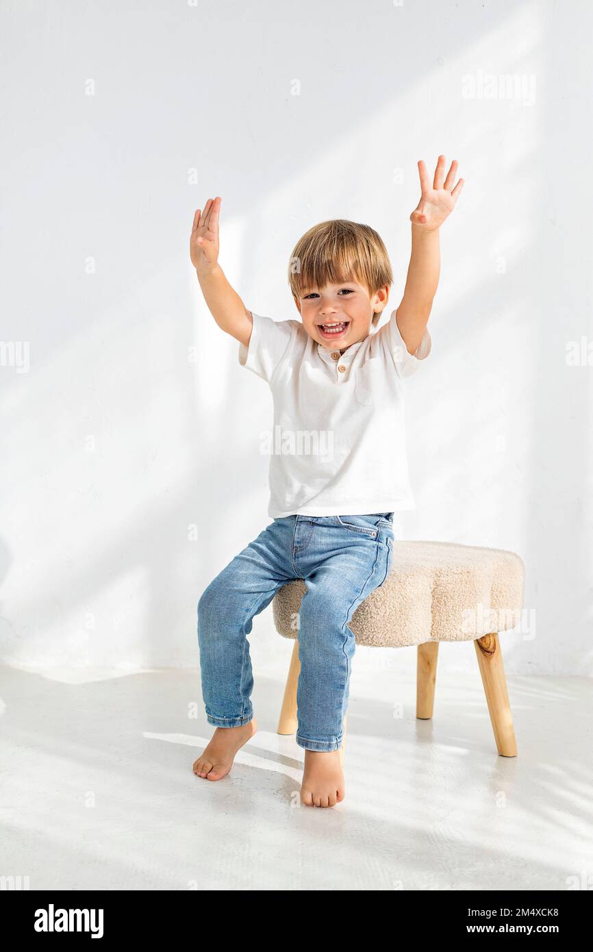 Boy sitting on stool hi-res stock photography and images - Alamy