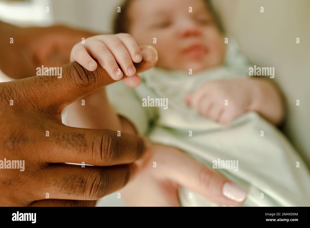 https://c8.alamy.com/comp/2M4XD6M/baby-girl-holding-finger-of-father-at-home-2M4XD6M.jpg