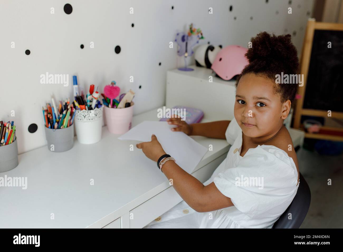 Side view african girl sitting hi-res stock photography and images - Alamy