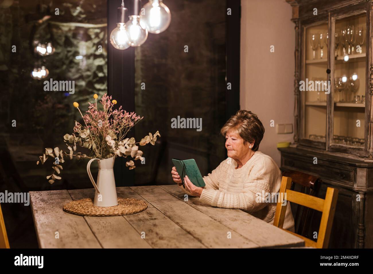 Senior woman using smart phone at home Stock Photo