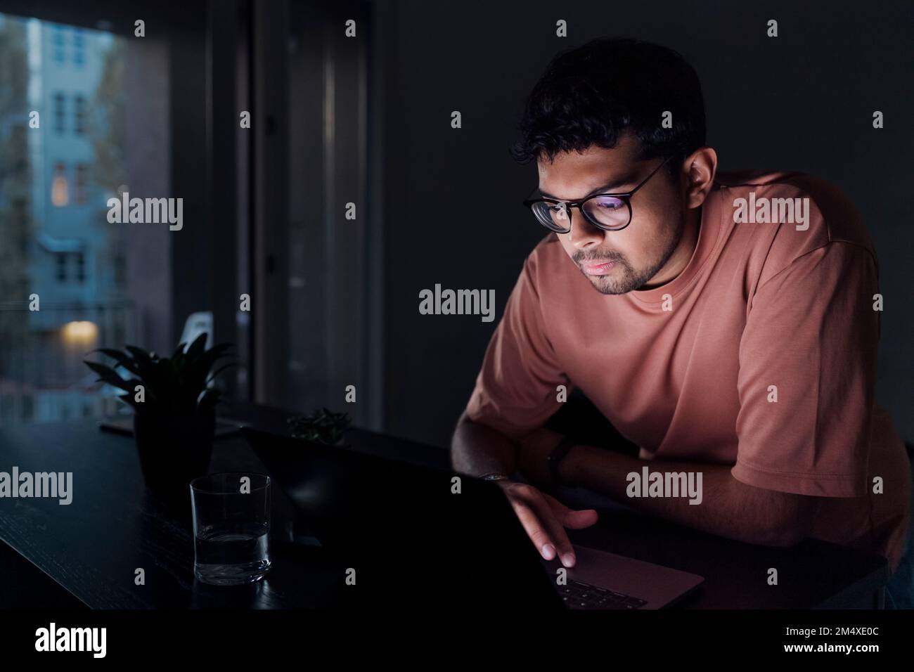 Young man using laptop at home Stock Photo
