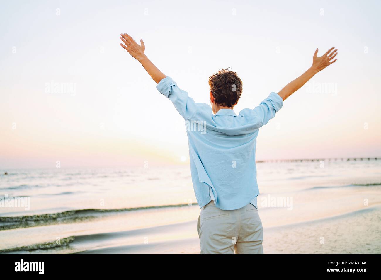 Woman standing sea raised arms hi-res stock photography and images - Alamy