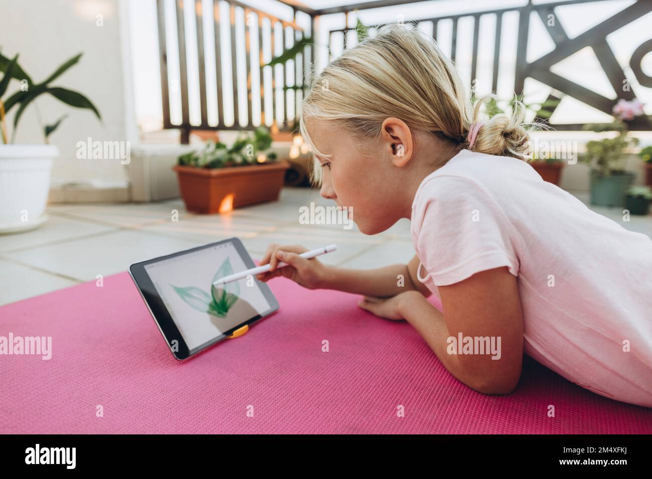 Girl drawing leaf on a tablet with digitized pen Stock Photo