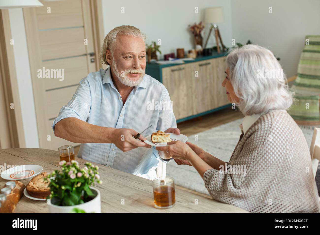 Senior couple having cake and tea at home Stock Photo