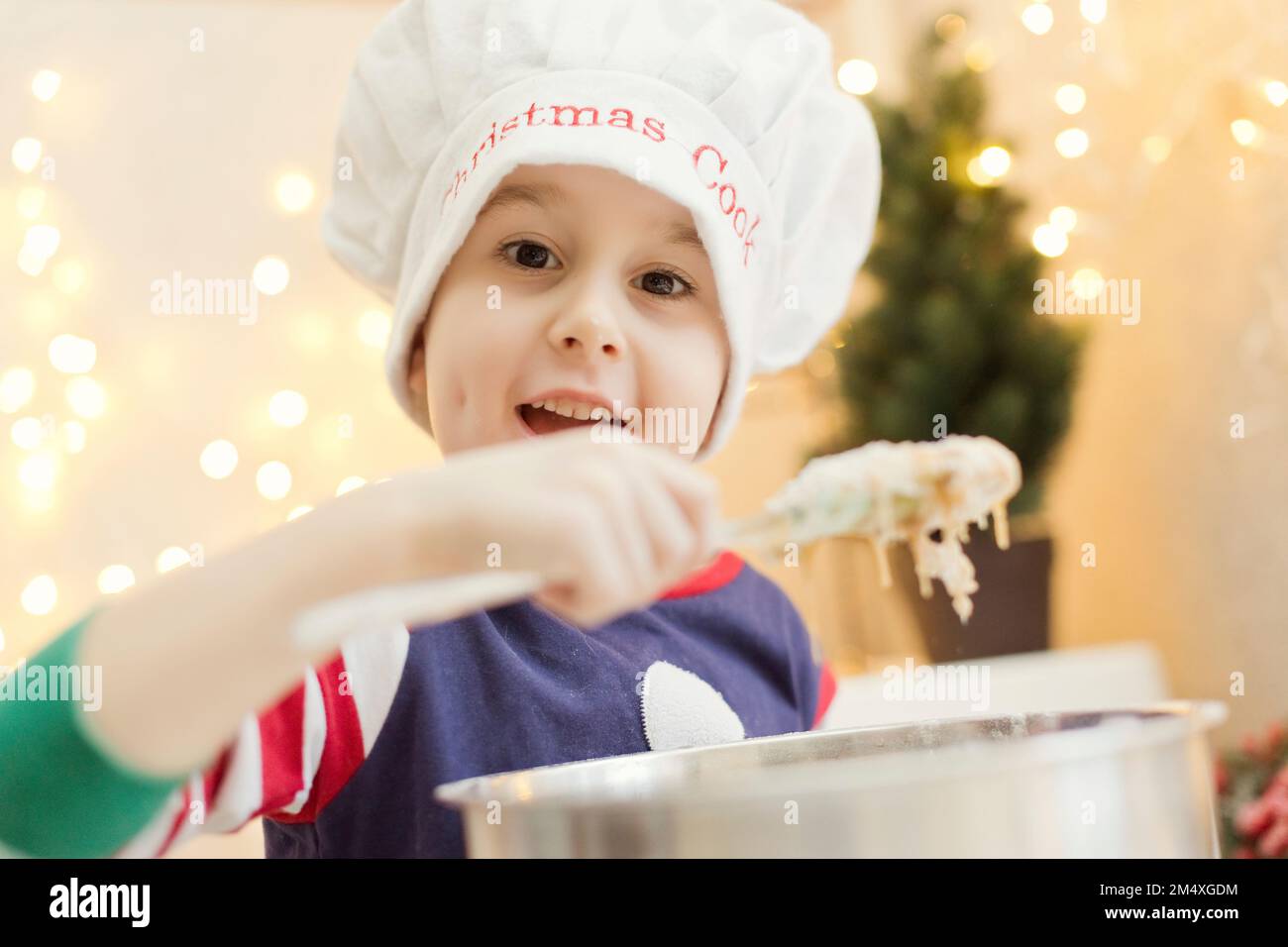 Cute boy preparing gingerbread dough at home Stock Photo