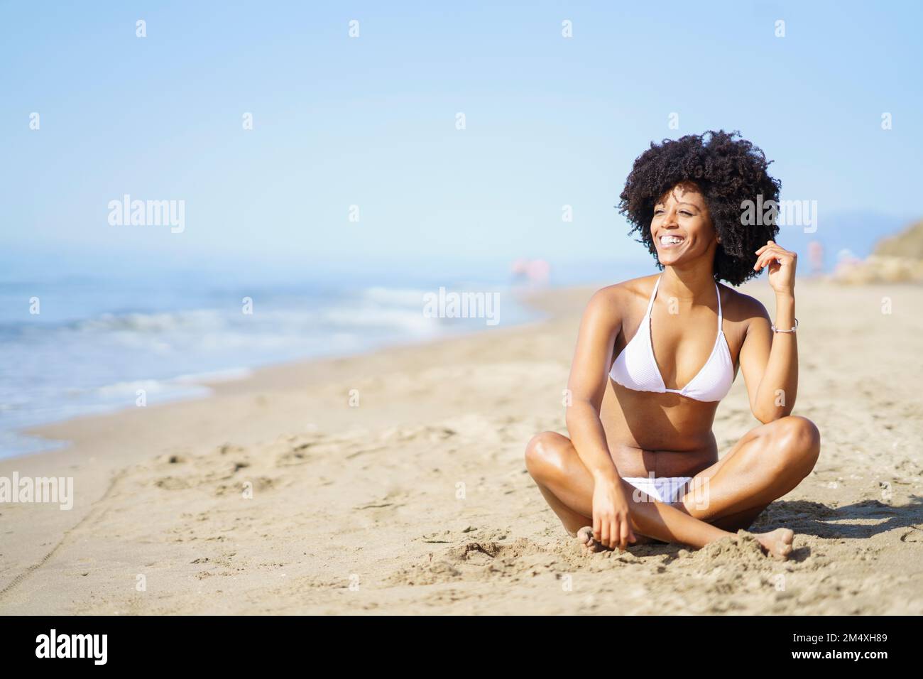 happy-young-woman-sitting-on-sand-at-beach-in-summer-stock-photo-alamy