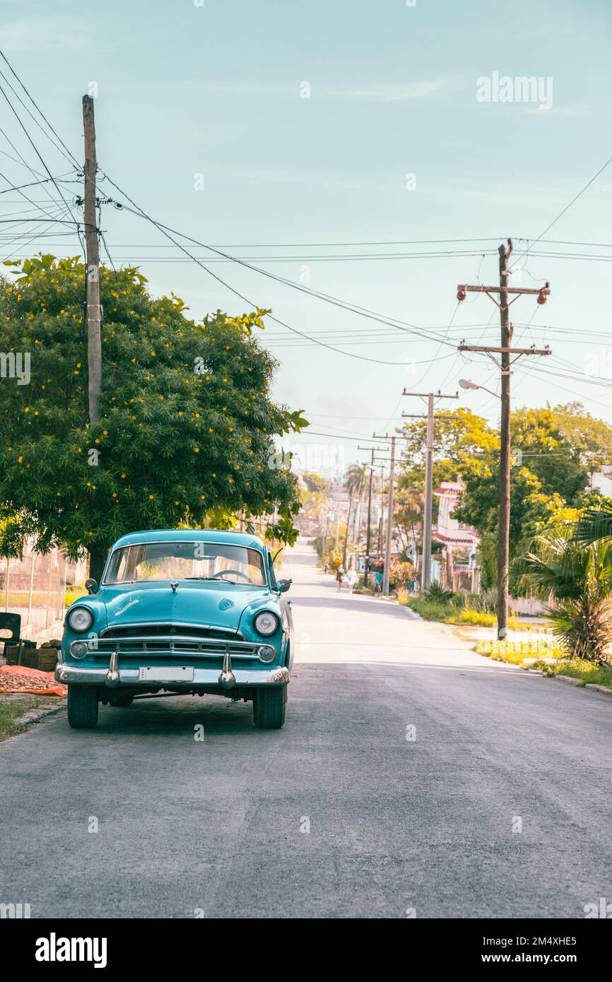 Cuba, Havana, Turquoise vintage car parked along street in La Vibora neighborhood Stock Photo