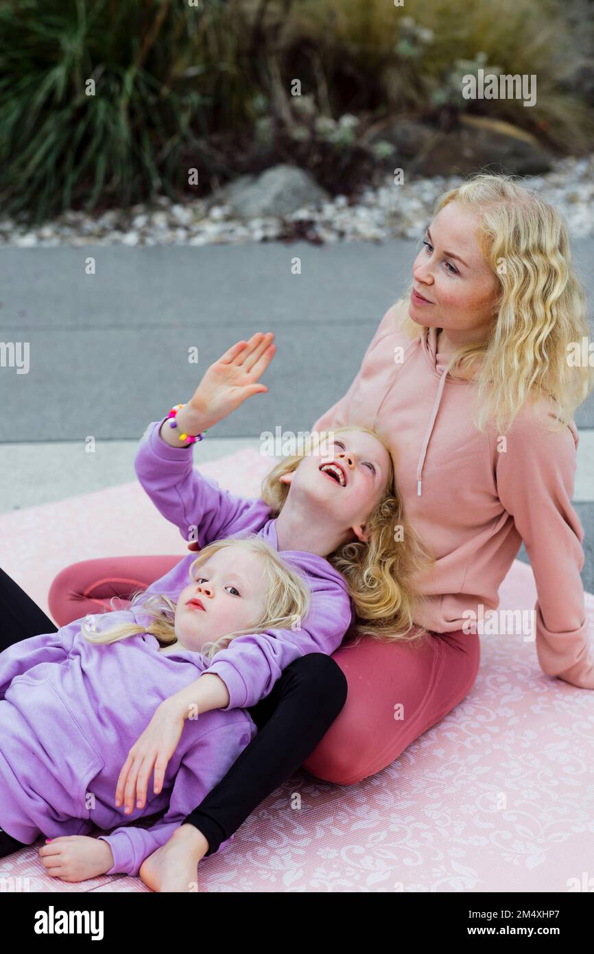 Mother and daughters spending time together at rooftop Stock Photo