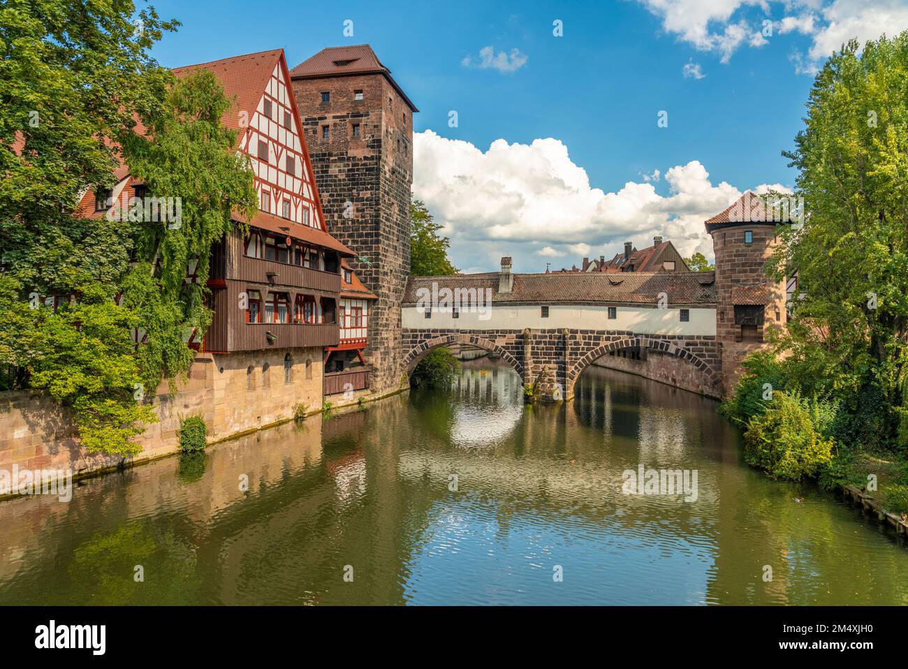 Germany, Bavaria, Nuremberg, View of Pegnitz river flowing through old town with Henkerhaus Museum in background Stock Photo
