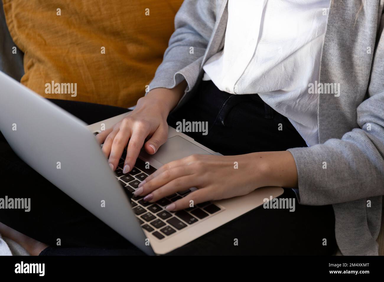 Young woman using laptop at home Stock Photo