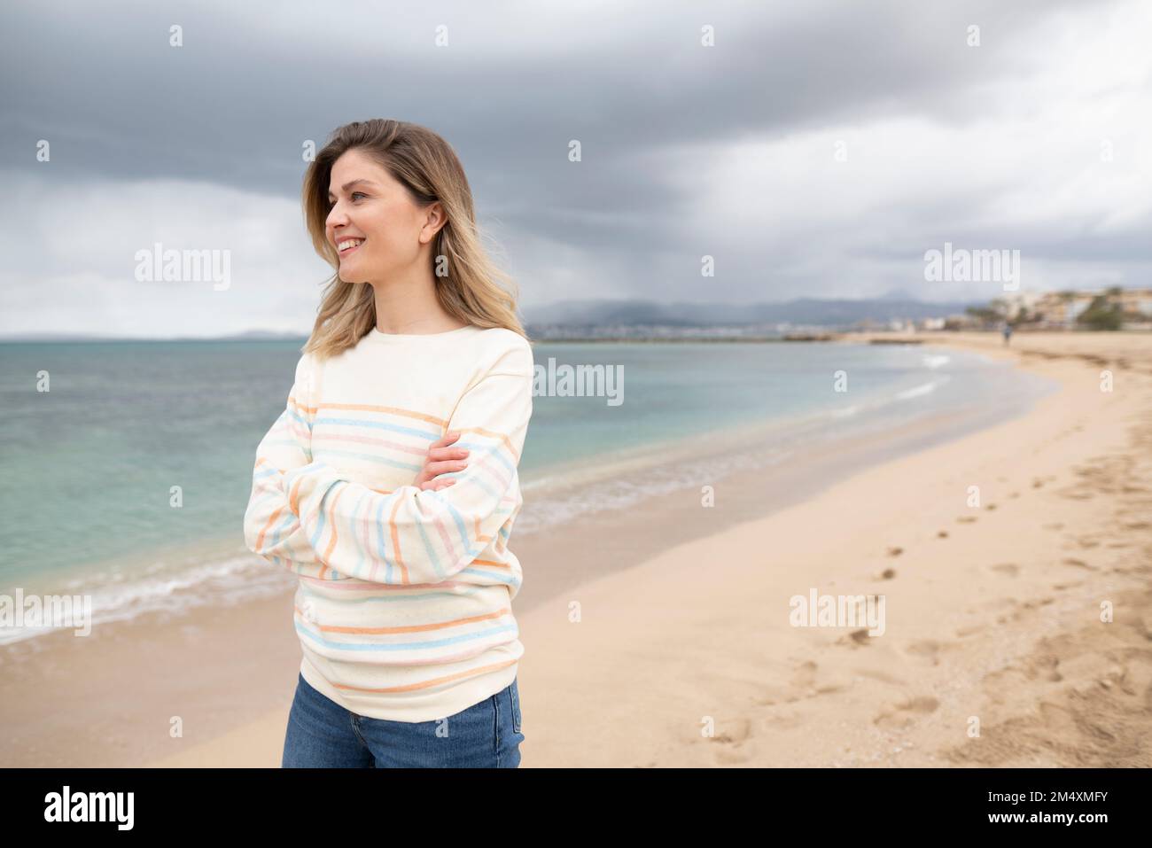 Woman walking on beach arms hi-res stock photography and images - Alamy