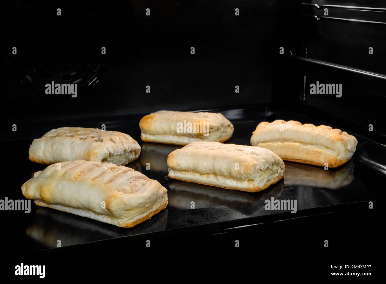 Five buns with ham, cheese baking in electric oven Stock Photo Alamy
