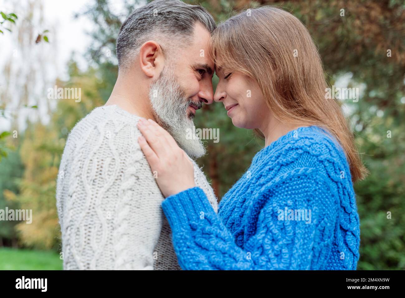 Mature man with woman standing face to face Stock Photo