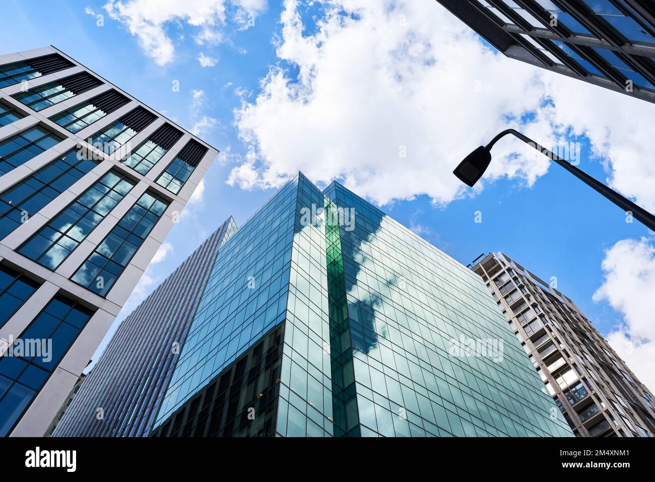 Tall modern skyscrapers in city under cloudy sky Stock Photo - Alamy
