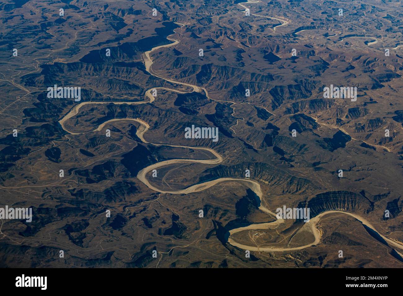 Oman, Dhofar Governorate, Aerial view of dry riverbed in winding canyon Stock Photo