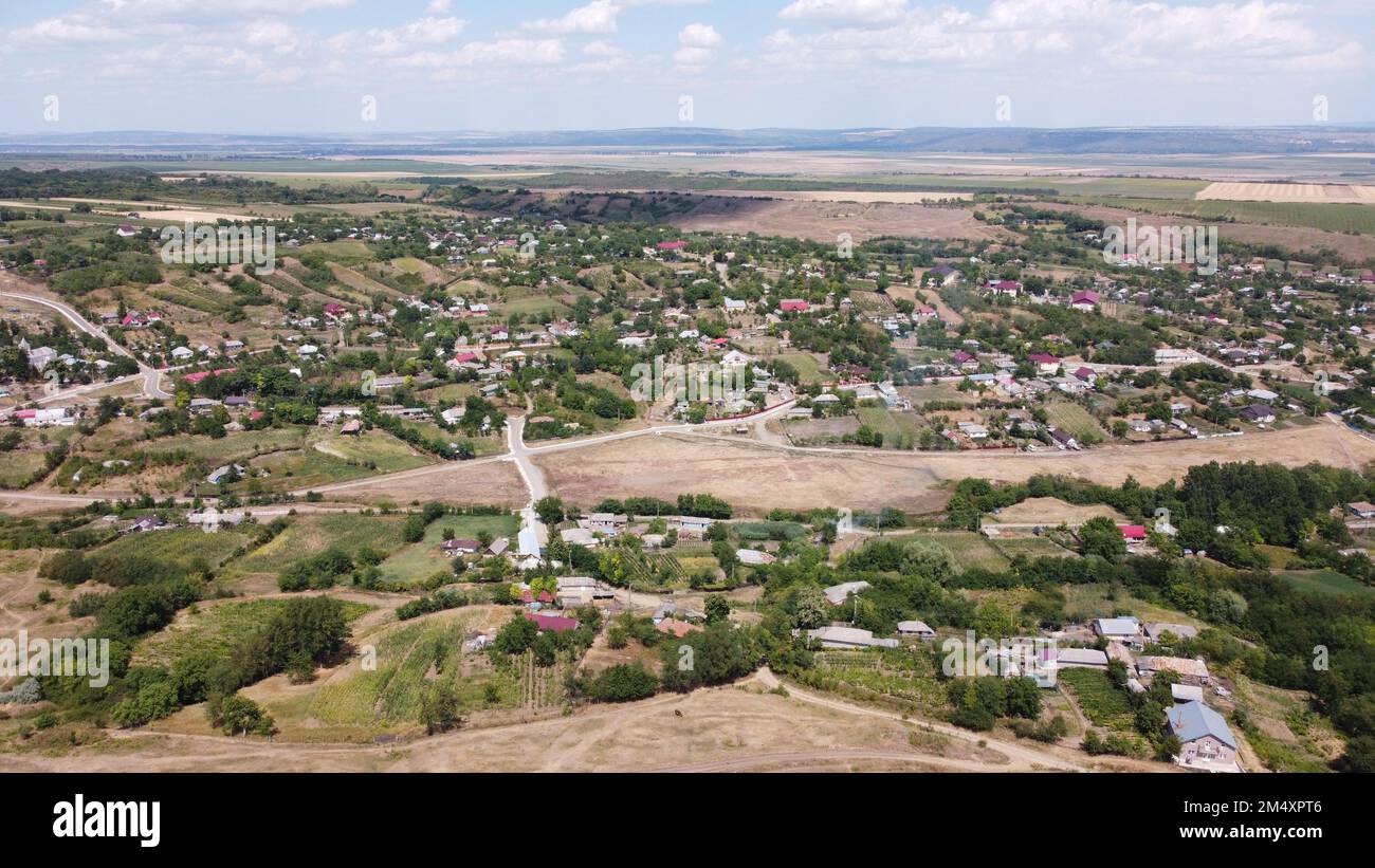 An aerial shot of a village under the big white clouds Stock Photo - Alamy