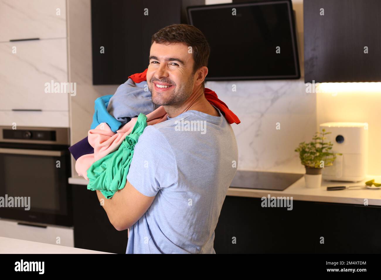 Cute man doing the laundry Stock Photo