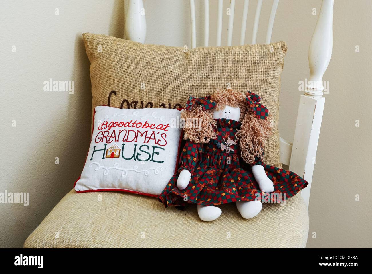 Cozy chair with welcoming pillow and doll at Grandmas house Stock Photo