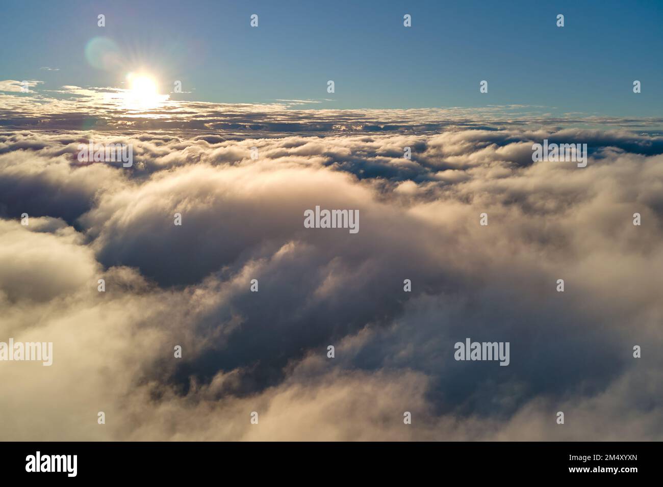 Aerial view from above at high altitude of dense puffy cumulus clouds ...