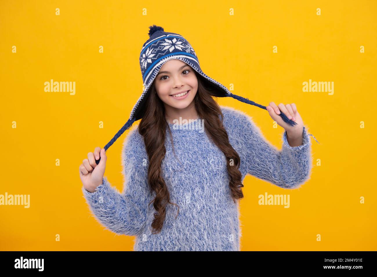 Modern teenage girl 12, 13, 14 year old wearing sweater and knitted hat