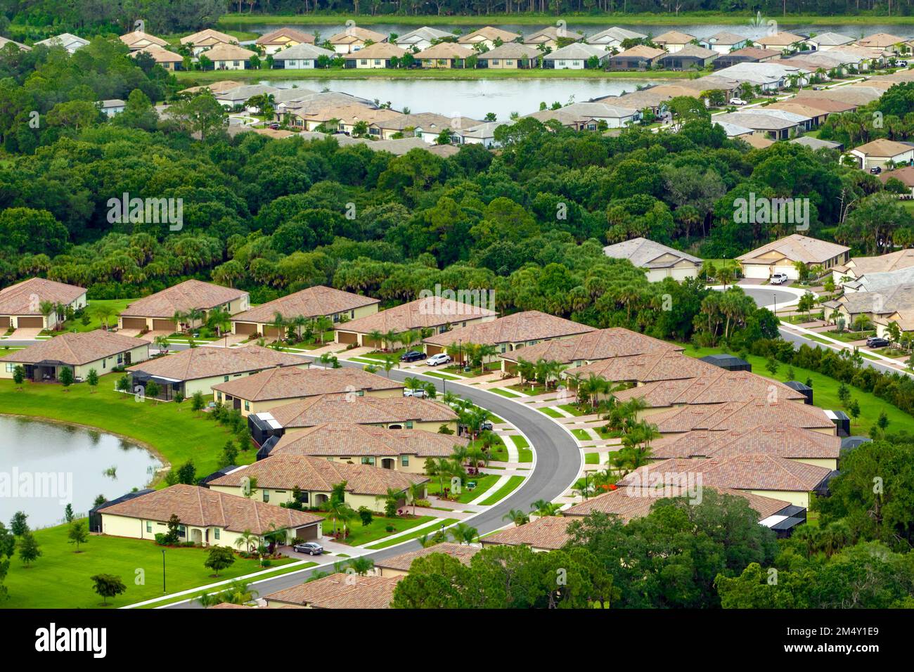 Aerial view of tightly located family houses in Florida closed suburban