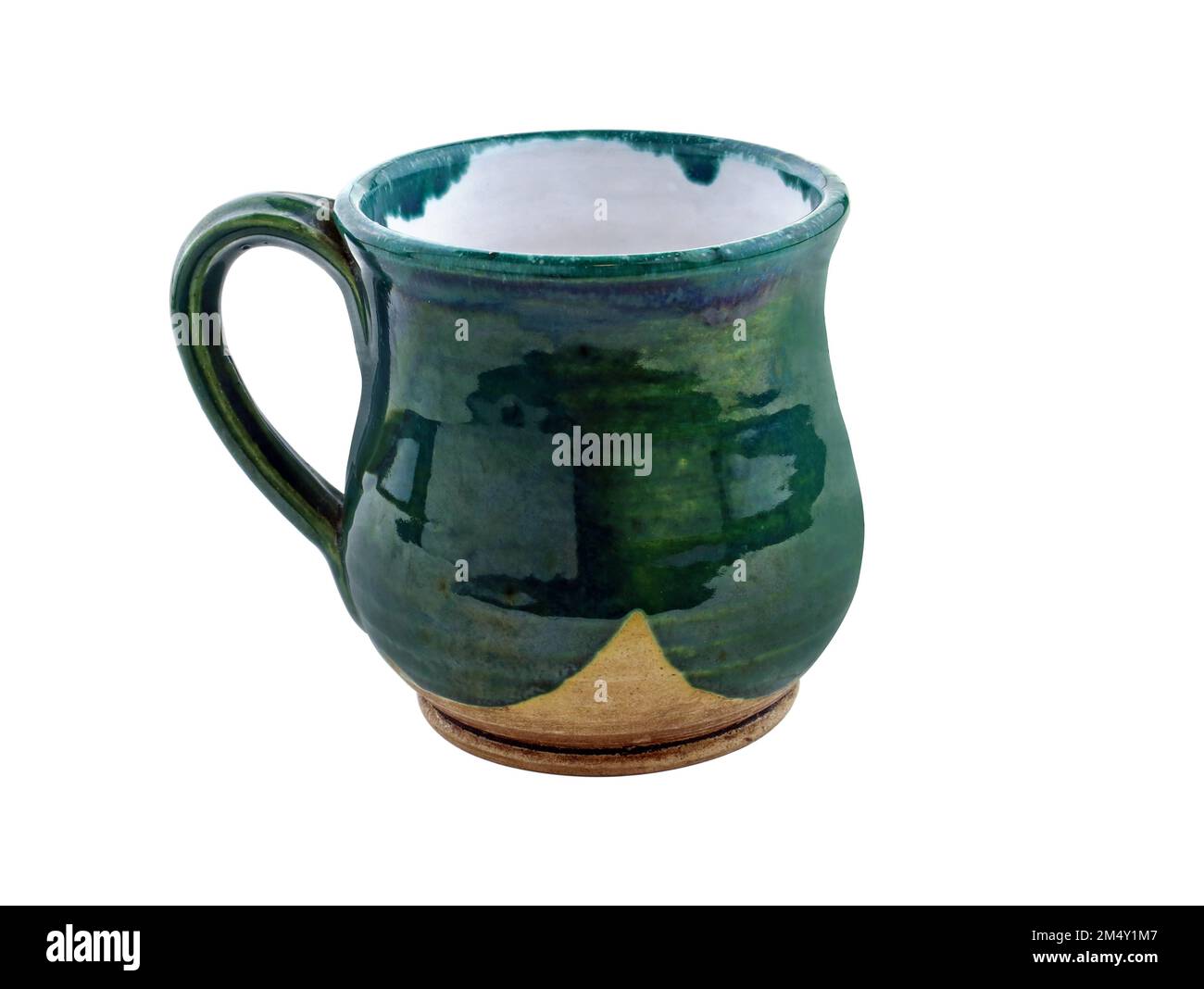 Curved ceramic cup. Mug green with handle made by hand. Pottery with glossy glaze. An empty green cup isolated on white Stock Photo