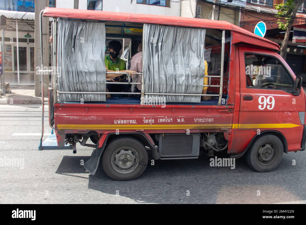 SAMUT PRAKAN, THAILAND, DEC 06 2022, A small passenger transport truck drives down the street Stock Photo