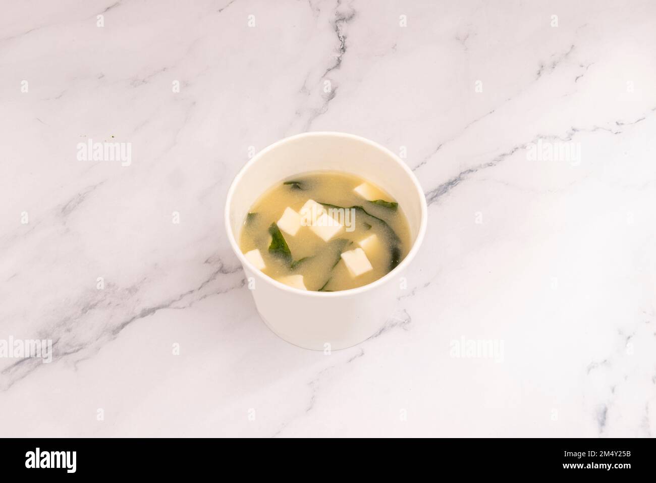 It is a Japanese soup prepared with a dashi broth and miso paste, which