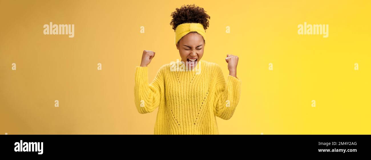 Excited thrilled beautiful young girl student yelling happily clench fists victory triumph pose dancing celebrating acception popular university Stock Photo