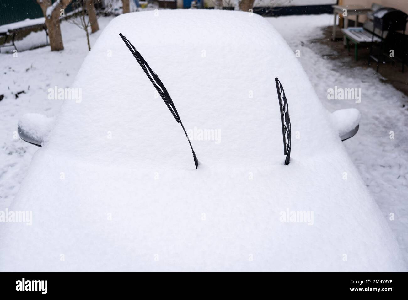 Car covered in snow, windshield in snow, wipers up Stock Photo Alamy