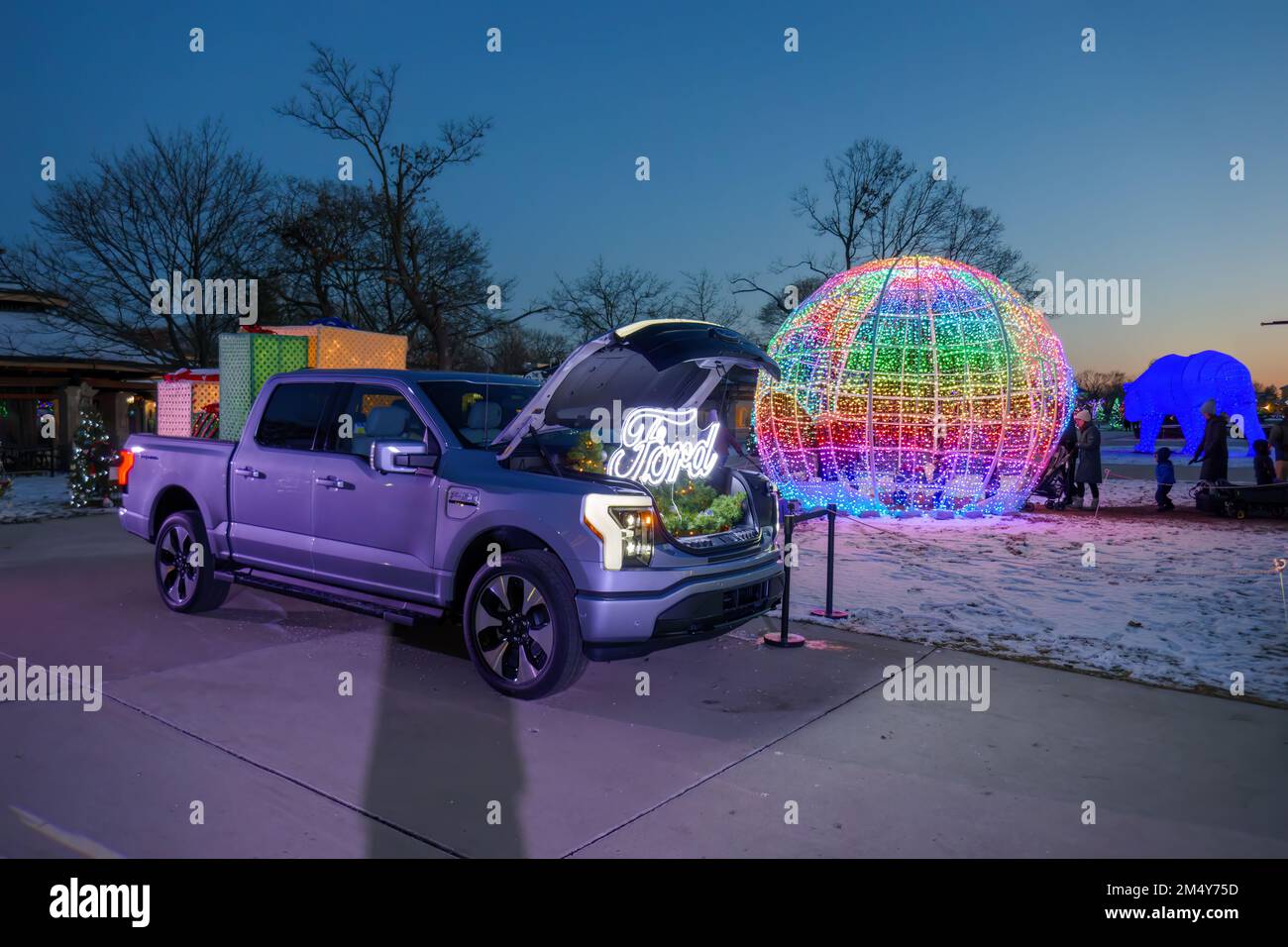 Fored F150 Lightning electric pickup truck on display. The truck is powering the lights of the big globe. Stock Photo