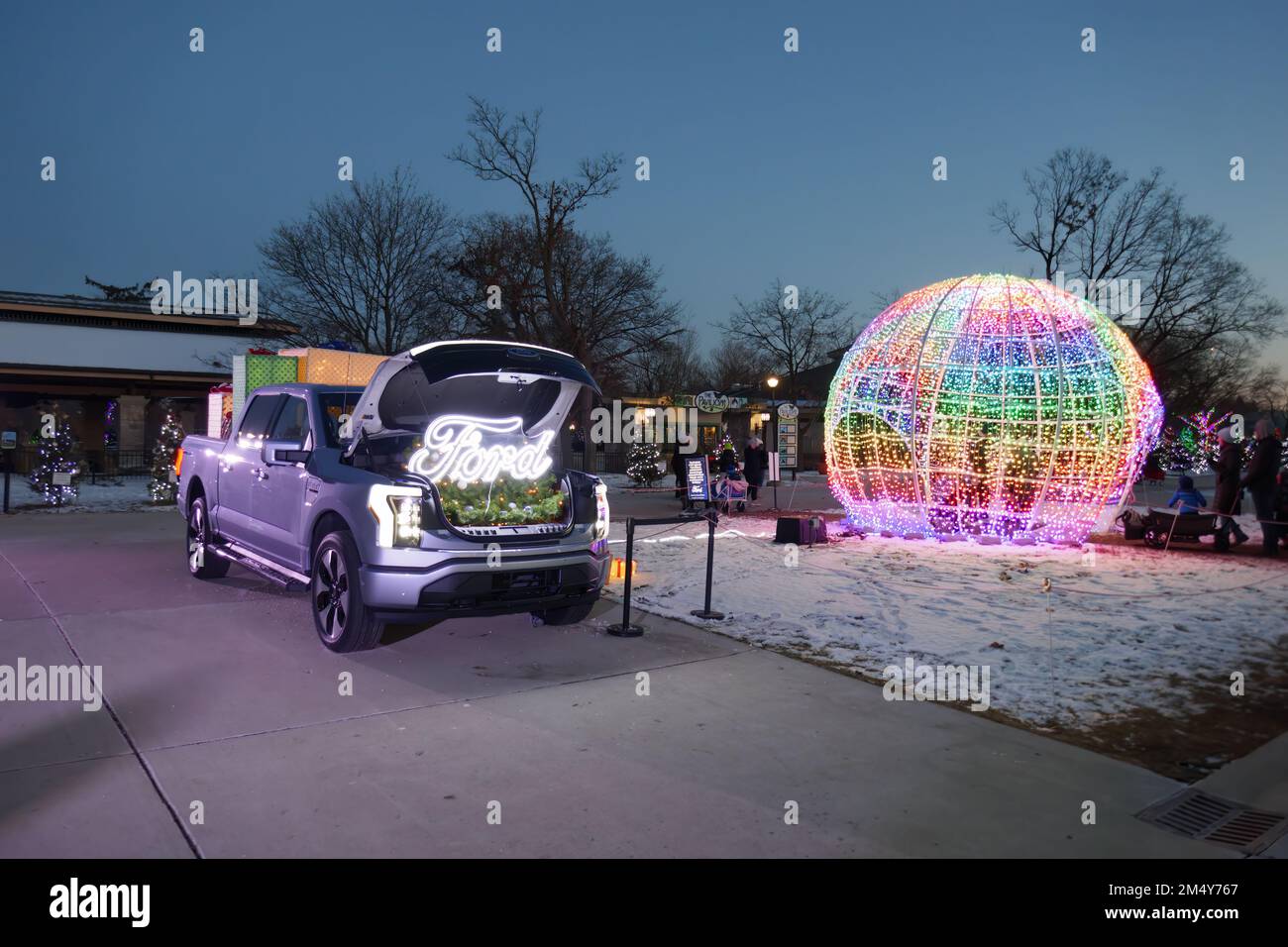 Fored F150 Lightning electric pickup truck on display. The truck is powering the lights of the big globe. Stock Photo