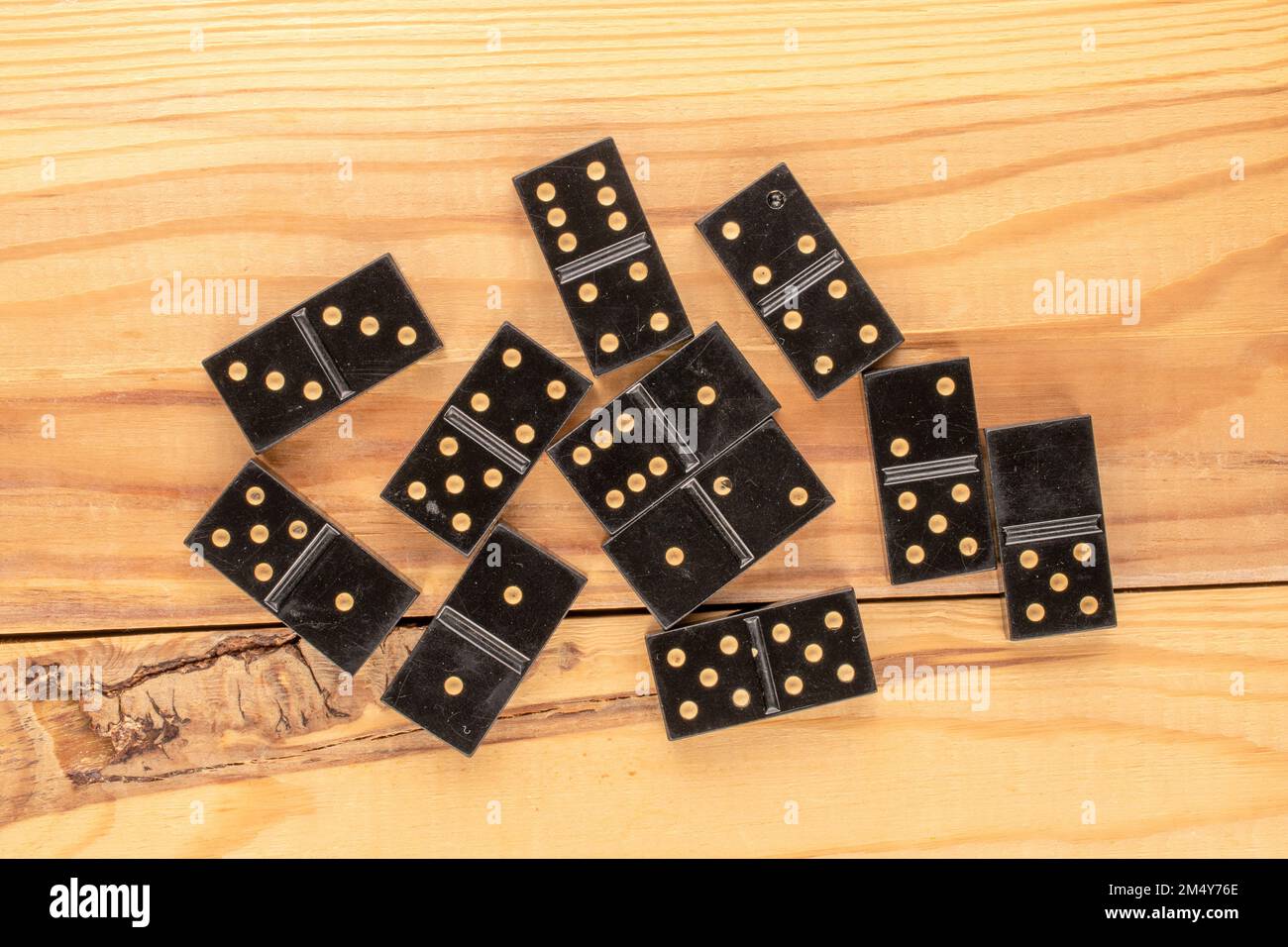 Several dominoes on a wooden table, macro, top view. Stock Photo