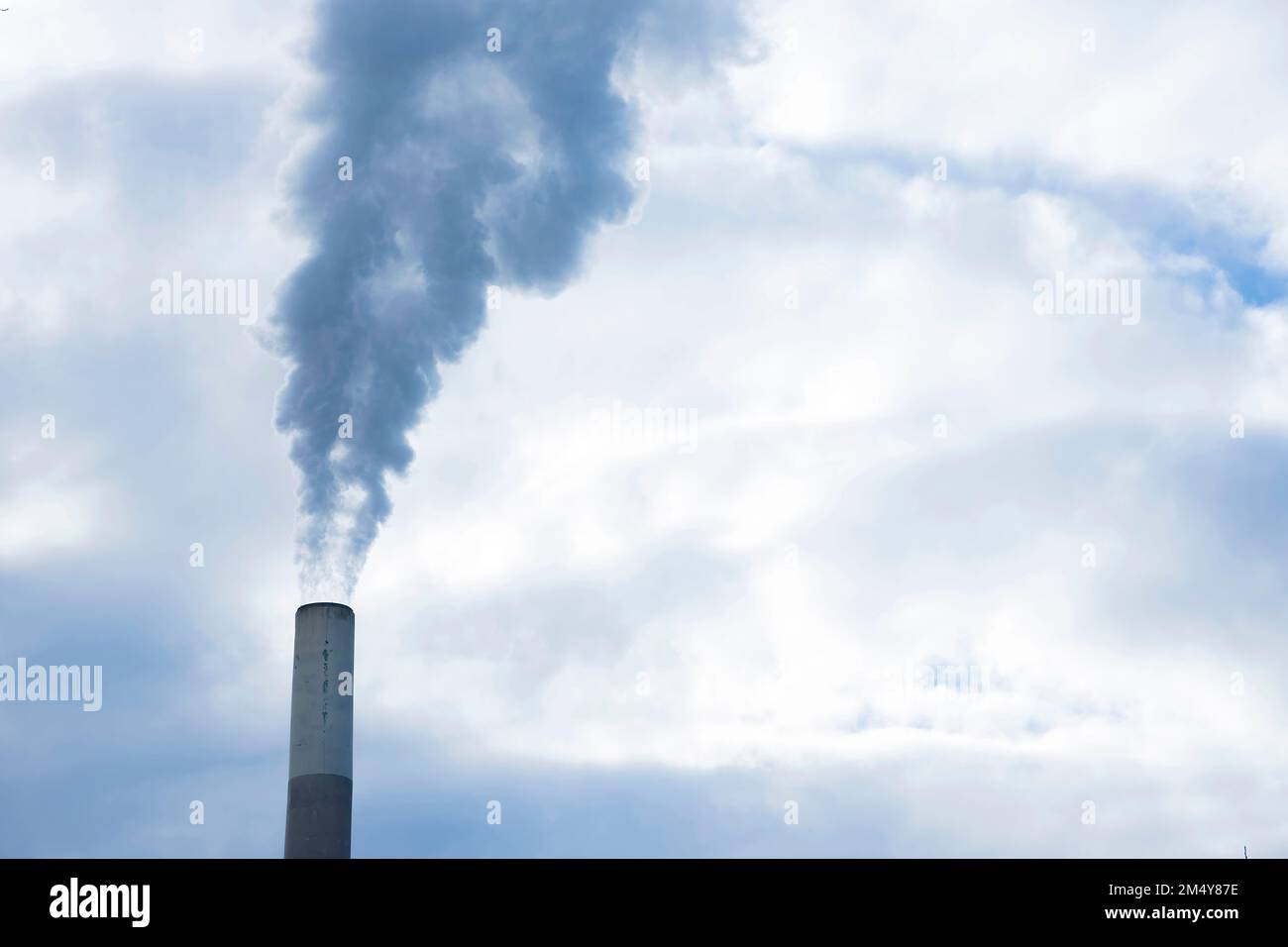 Industrial chimney, thermal power plant, pollution in the air, steam cooling tower in Graz, Styria region, Austria. Stock Photo