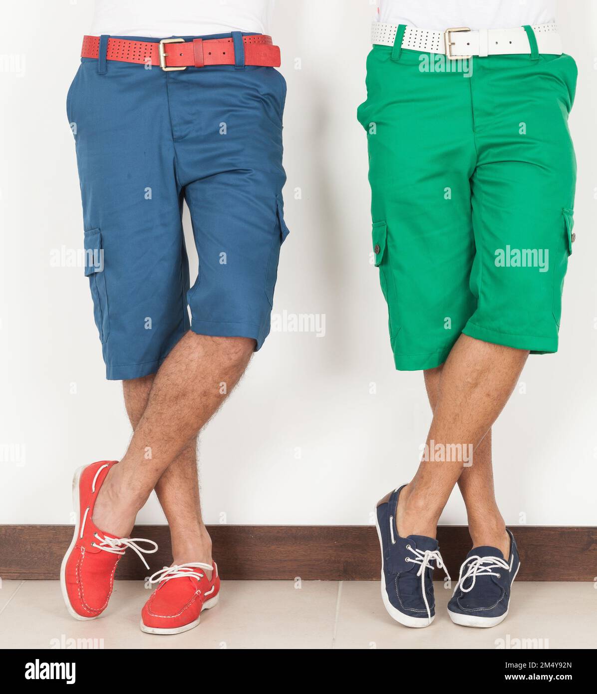Two Men In Shorts Green And Blue Colors On White Background. Stock Photo