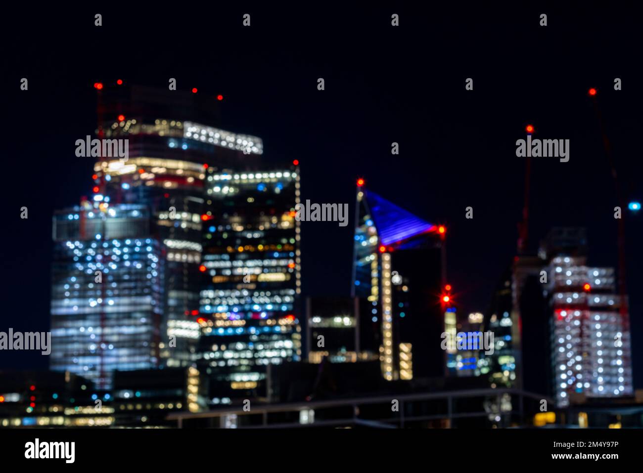 Blurred image of Nightlife in London, busy traffic on the bridge over the river Thames near the business district with glittering skyscrapers Stock Photo