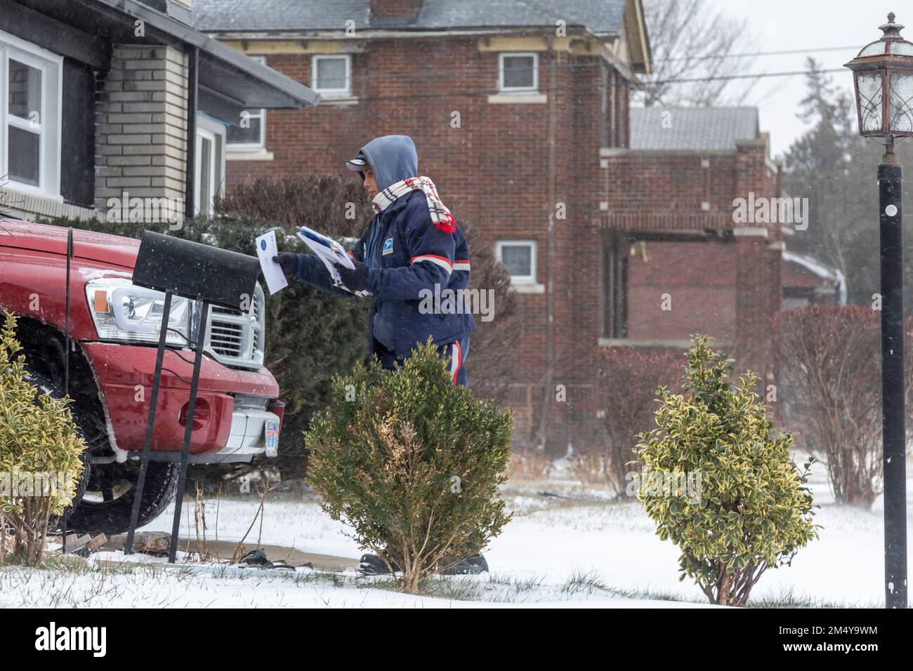 Detroit, Michigan, USA. 23rd Dec, 2022. Deborah Williams delivers the mail during a widespread winter storm that brought dangerous cold, snow, and wind to much of the United States. In Detroit, temperatures were near 0 degrees F, with the wind chill at -19 F. Credit: Jim West/Alamy Live News Stock Photo