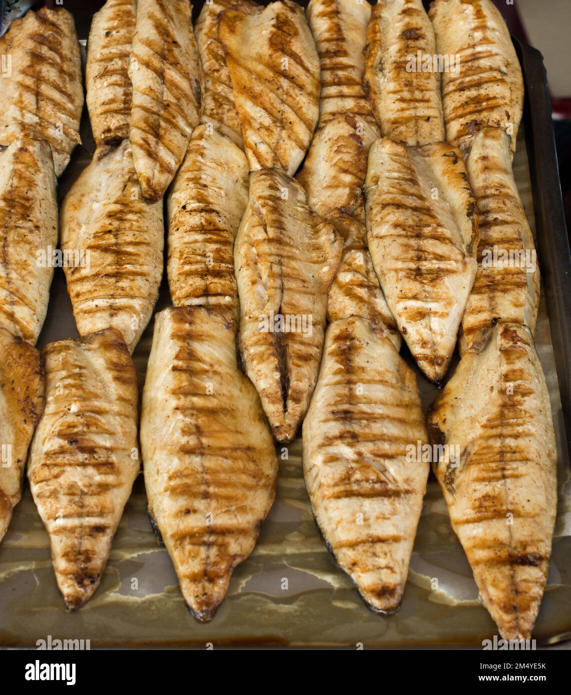Fish on the grill as seafood ready to eat Stock Photo