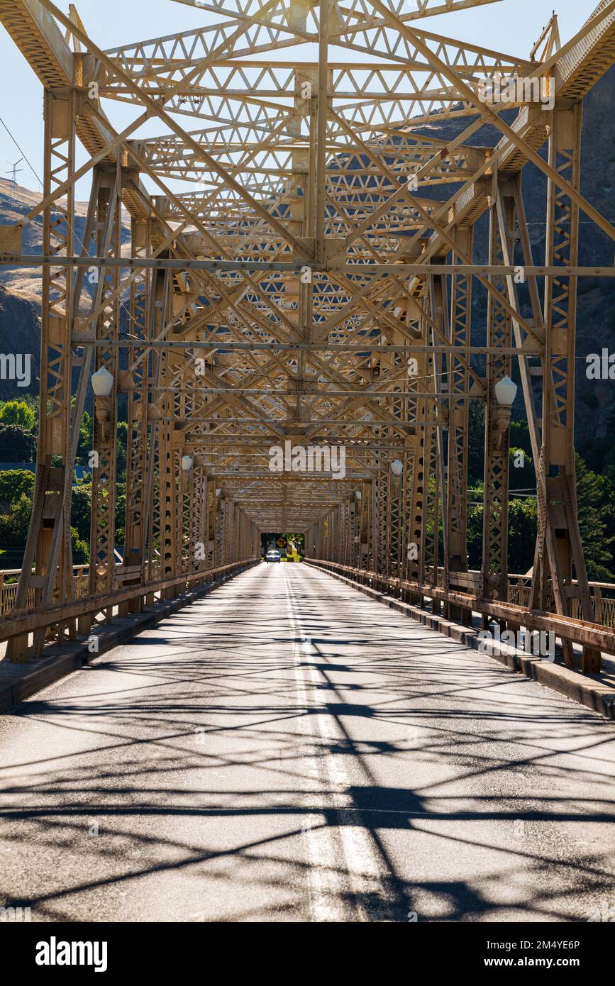 Steel structure of Grand Coulee Bridge casts abstract shadows on road