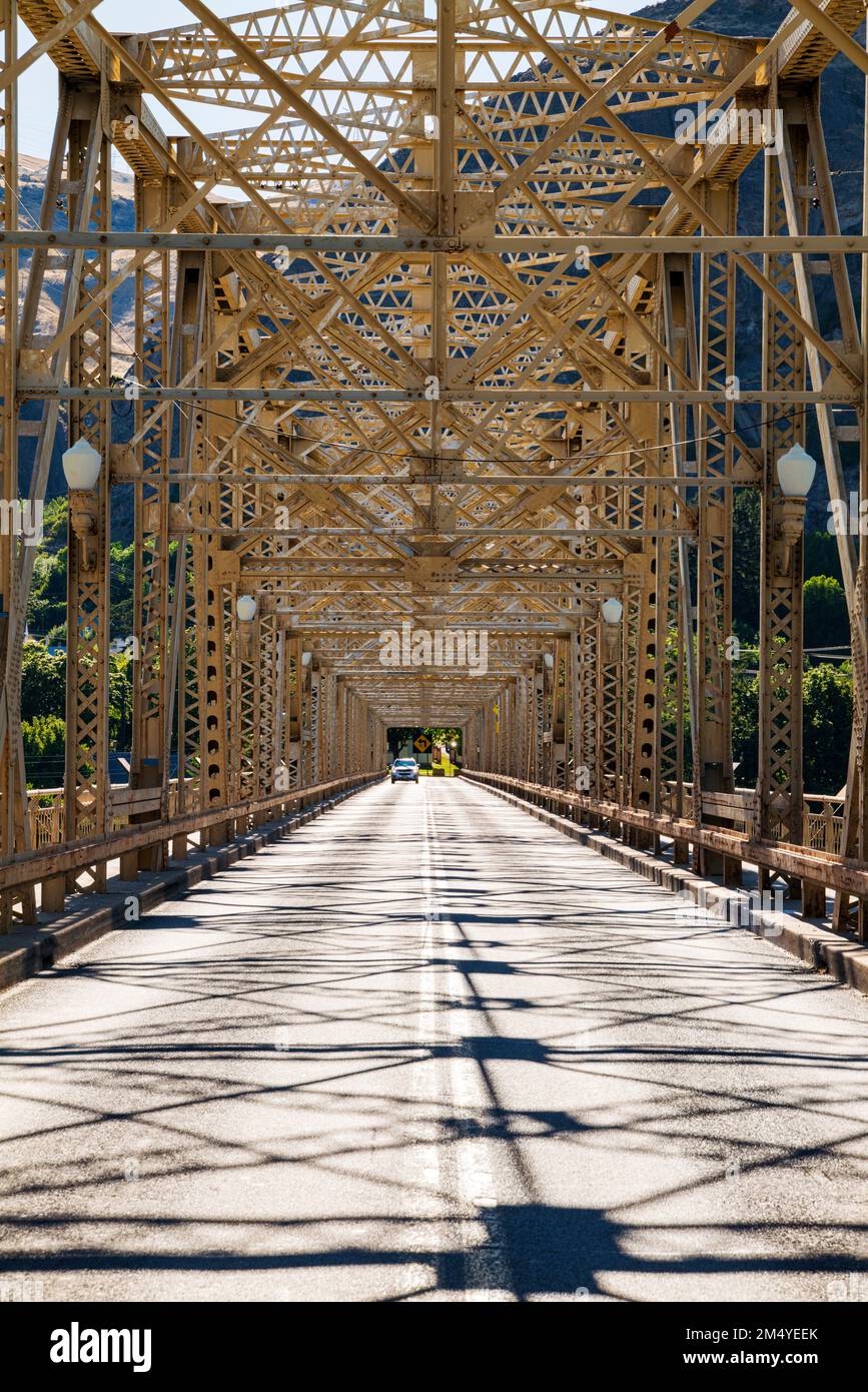 Steel structure of Grand Coulee Bridge casts abstract shadows on road
