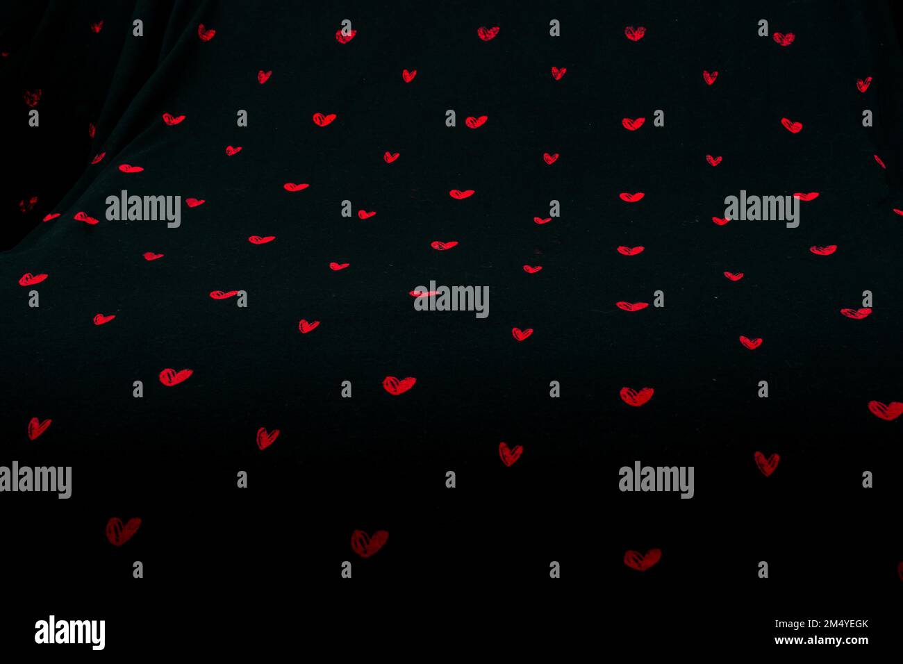 Black fabric background with red hearts shapes Stock Photo - Alamy